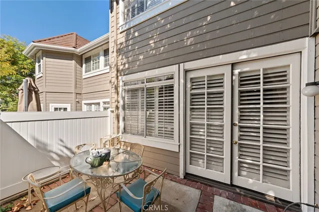 a balcony with table and chairs