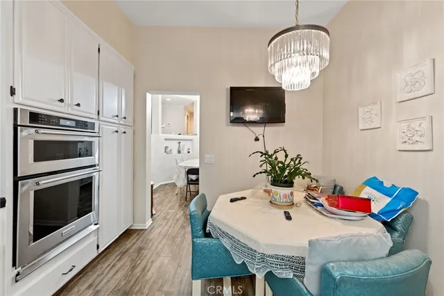 a view of a dining room with furniture wooden floor and chandelier