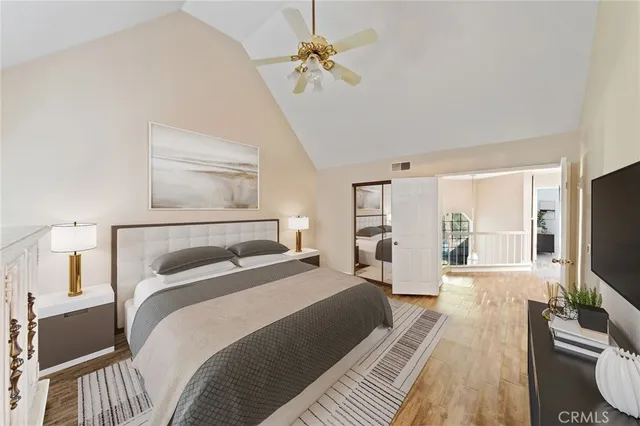 a bedroom with a bed flat screen tv and a couch