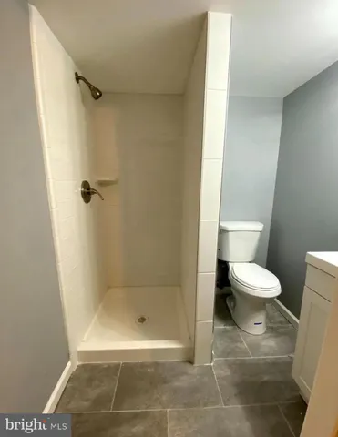 a bathroom with a toilet and a shower