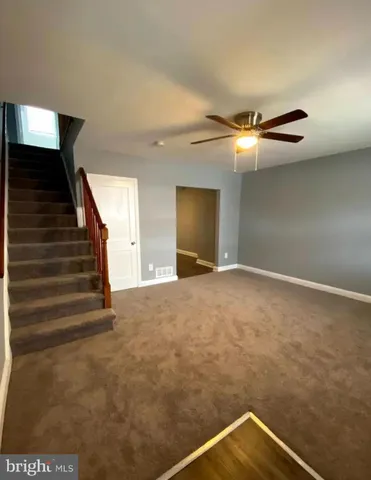a view of an empty room with stairs