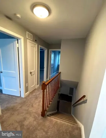 a view of a hallway with staircase