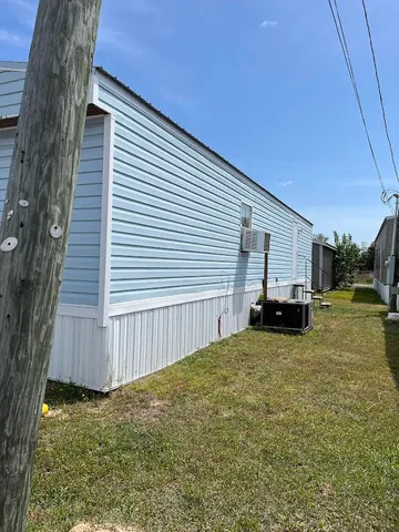 a view of a house with backyard and deck