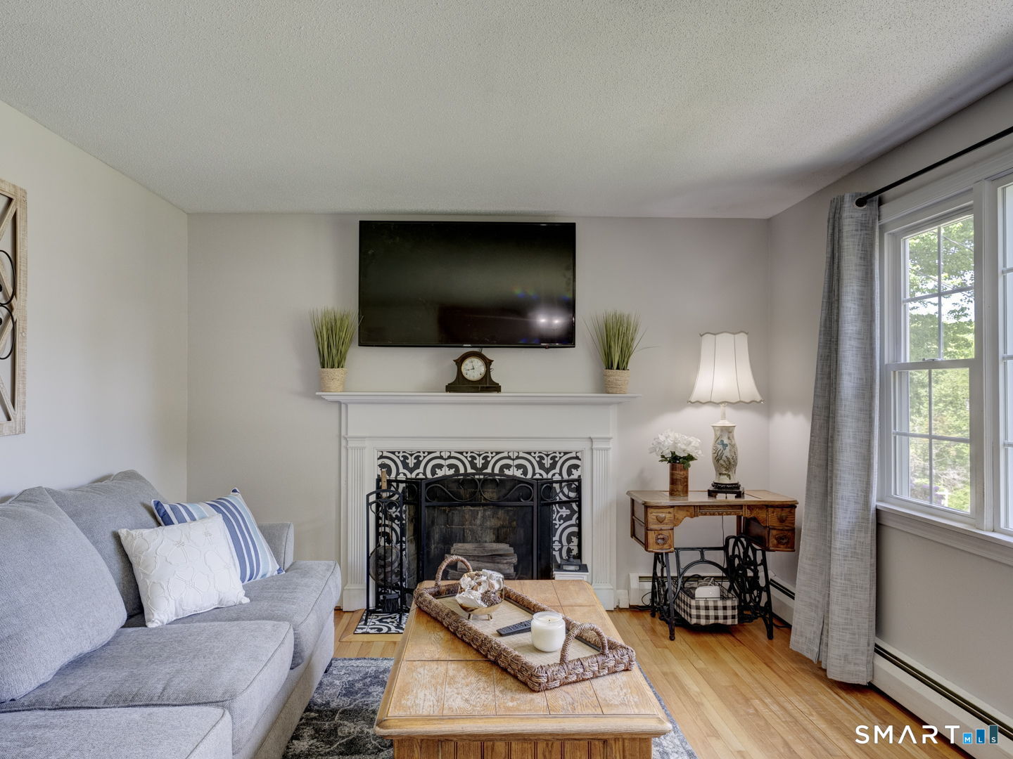 39 Freedom Drive Canton, CT 06019 - Photo 5 of 37 a living room with furniture a flat screen tv and a fireplace