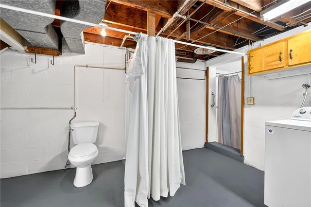 a bathroom with a toilet and a shower