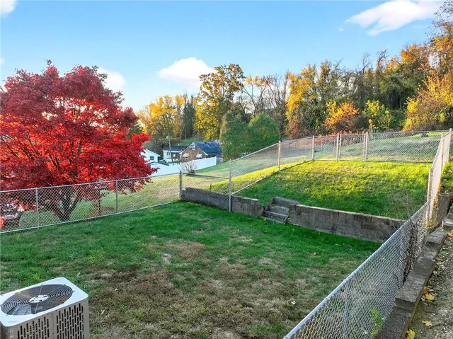 a view of a backyard with large trees