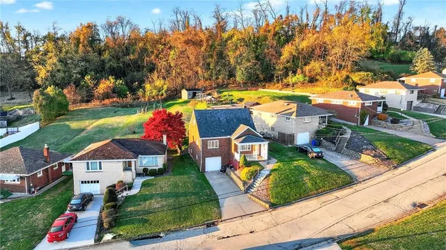 an aerial view of residential houses with yard