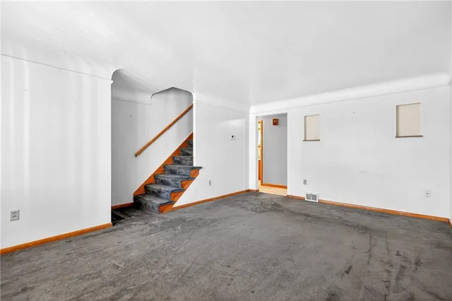 a view of an empty room with stairs