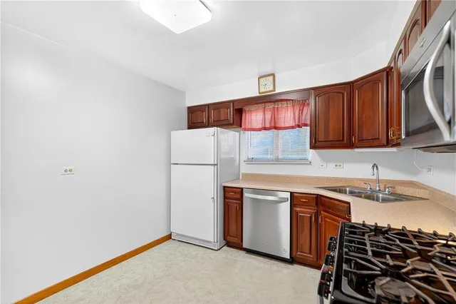 a kitchen with stainless steel appliances a sink and a refrigerator