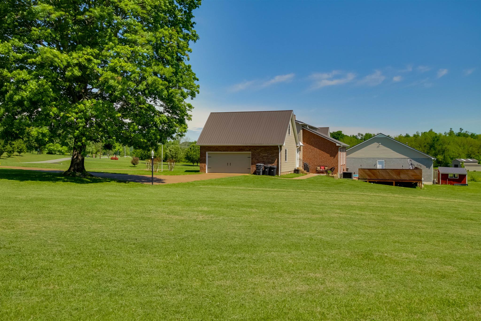 408 Ranch Road Portland, TN 37148 - Photo 26 of 29 View of side of home w/2 car garage. Nice long circle driveway brings you right to your doorstep. Many upgrades: new septic system, tin roof (2015), sump pump & french drain, new siding w/house wrap, main level HVAC w/filtration system & much more