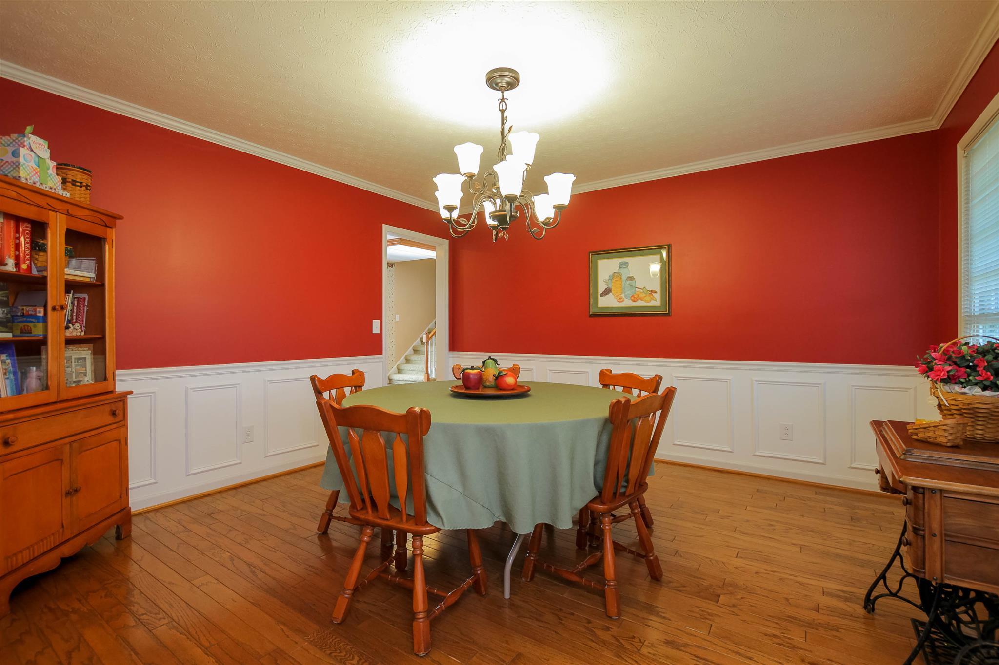 408 Ranch Road Portland, TN 37148 - Photo 6 of 29 Formal dining area features a wainscoting, crown molding, hardwood floors and a new chandelier.