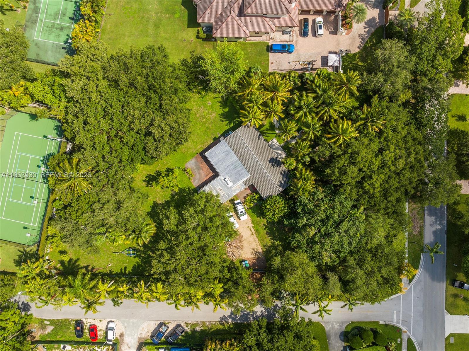 6701 Southwest 115th Street Pinecrest, FL 33156 - Photo 2 of 2 a aerial view of a house with a yard and garden