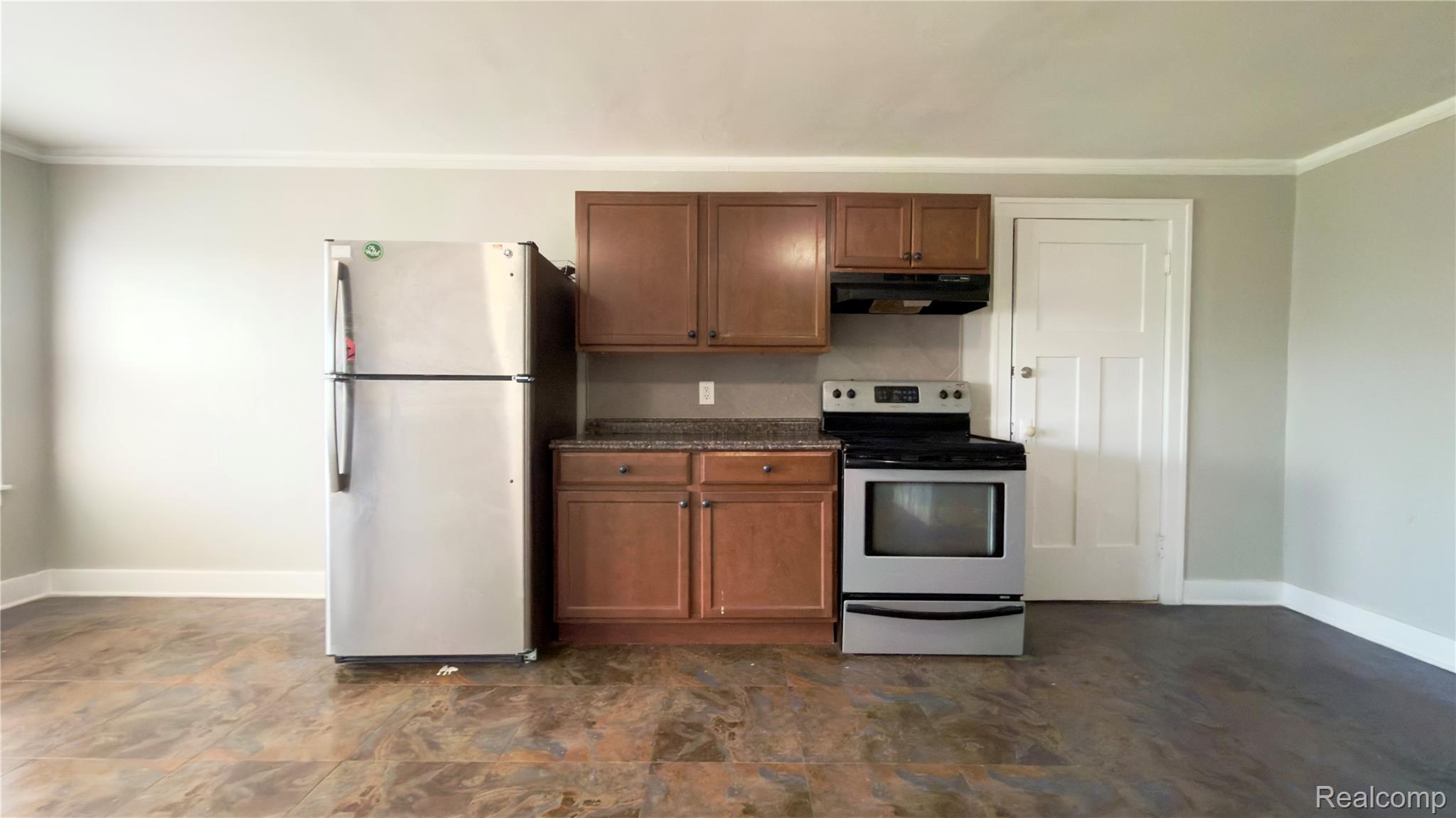 1651 Atkinson Street, Unit 3 Detroit, MI 48206 - Photo 6 of 11 Kitchenette featuring wood-finish cabinetry and stone-look countertops