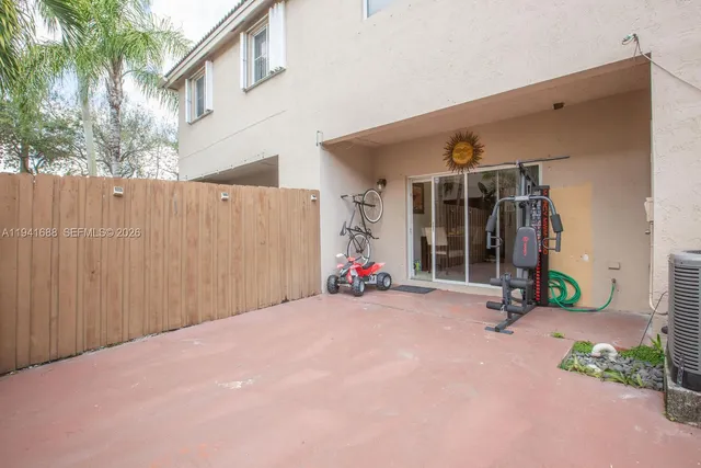 a view of a house with potted plants and a garage