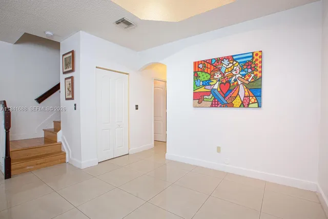 an entryway with a painting on the wall