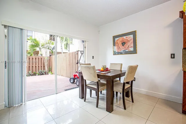 a view of a dining room with furniture and a potted plant