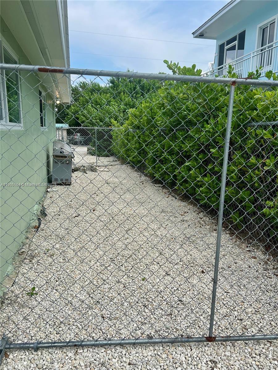 59 Tarpon Avenue Key Largo, FL 33037 - Photo 11 of 16 a backyard of a house with lots of green space