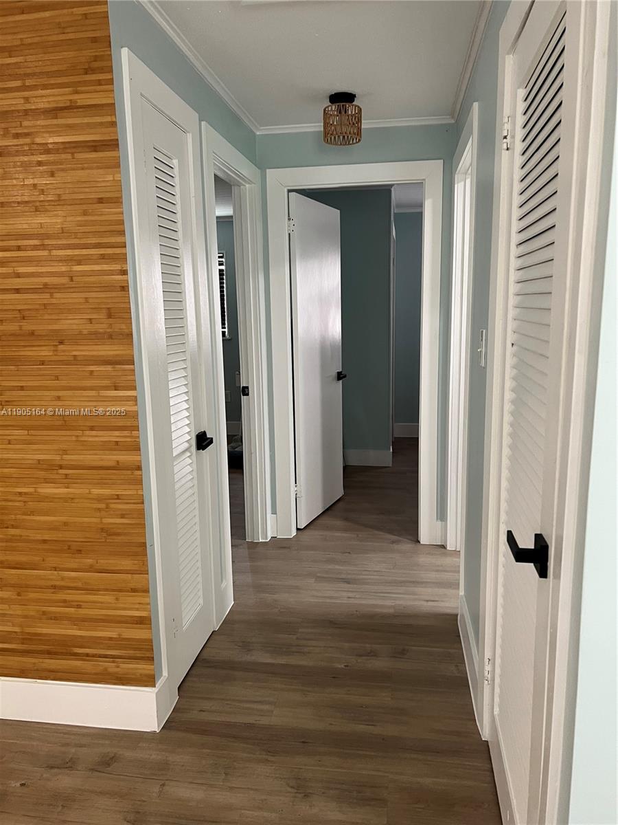 59 Tarpon Avenue Key Largo, FL 33037 - Photo 12 of 16 a view of a hallway with wooden floor and a bathroom