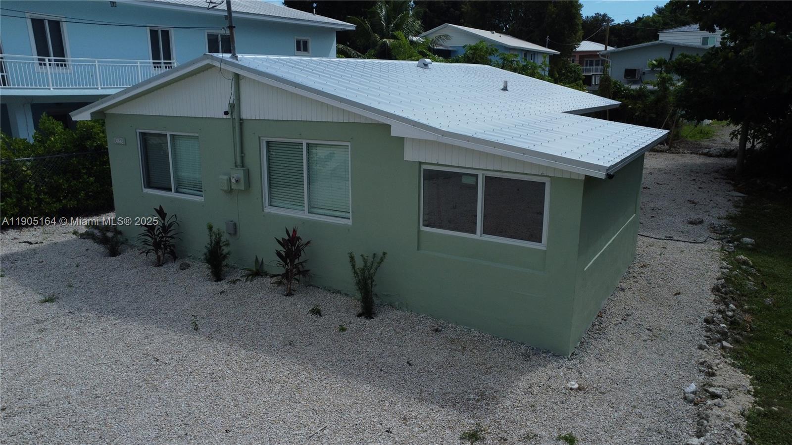 59 Tarpon Avenue Key Largo, FL 33037 - Photo 14 of 16 a front view of a house with garden