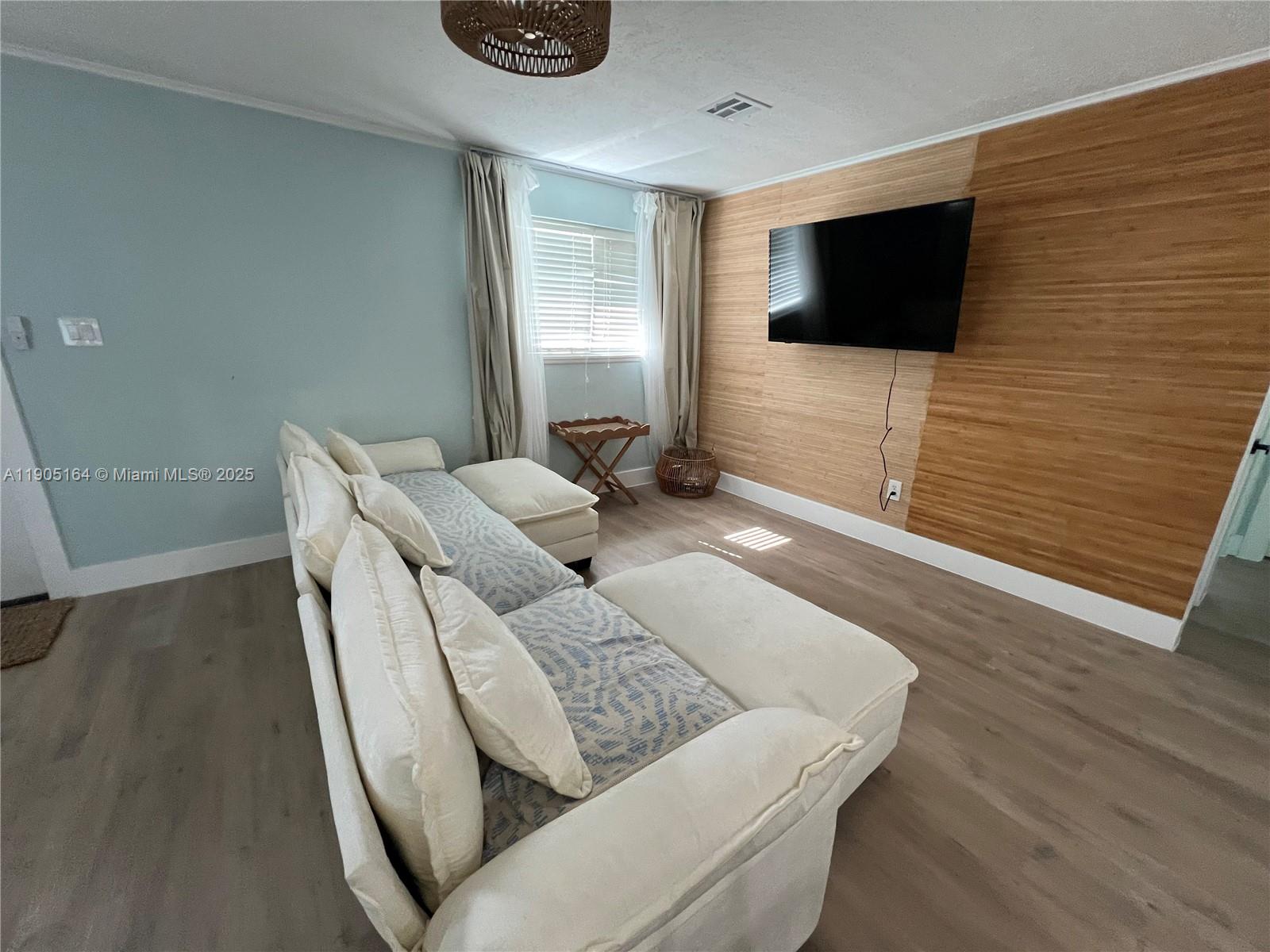 59 Tarpon Avenue Key Largo, FL 33037 - Photo 6 of 16 a living room with furniture and a flat screen tv