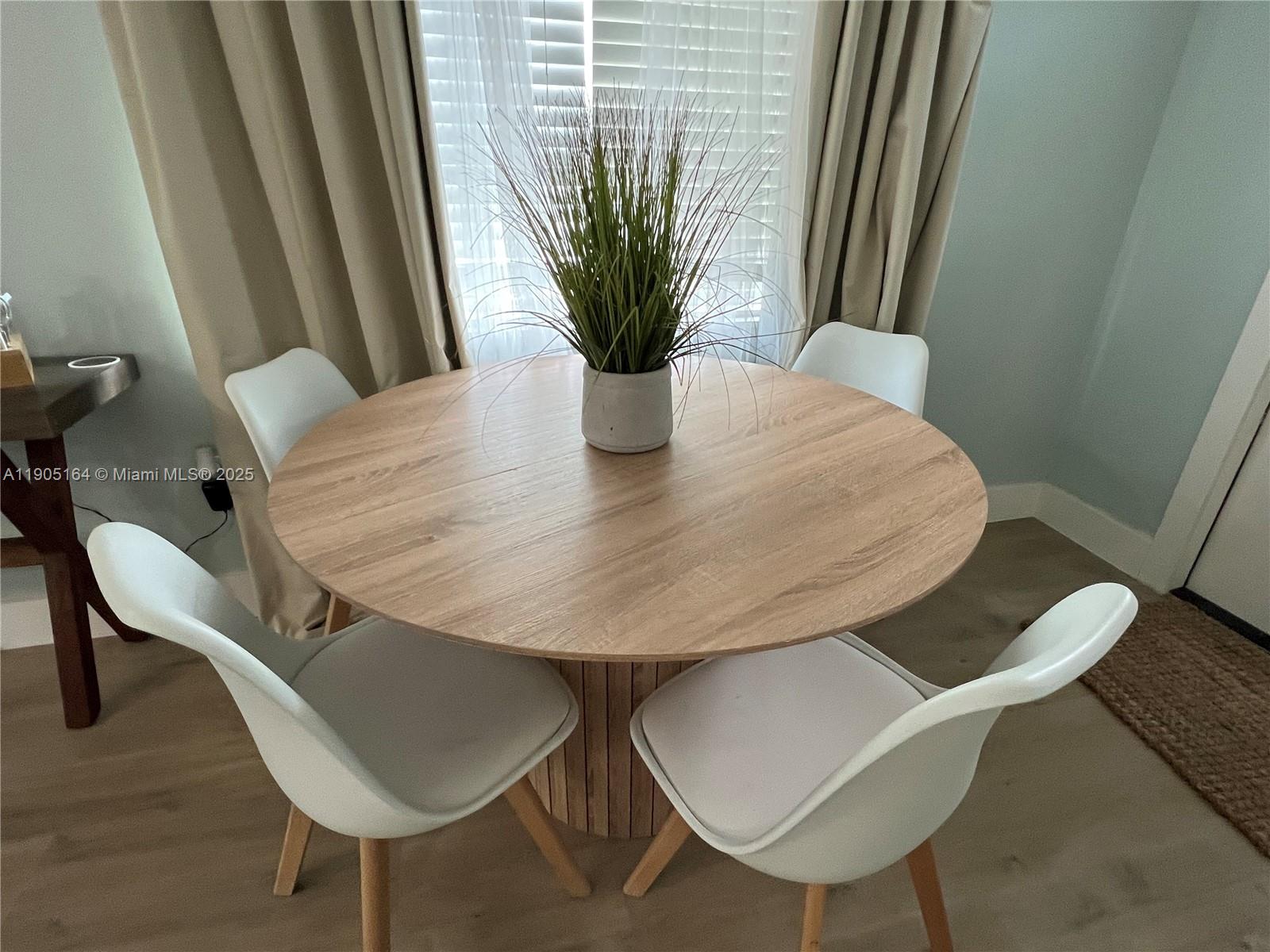 59 Tarpon Avenue Key Largo, FL 33037 - Photo 7 of 16 a view of a dining room with furniture and wooden floor