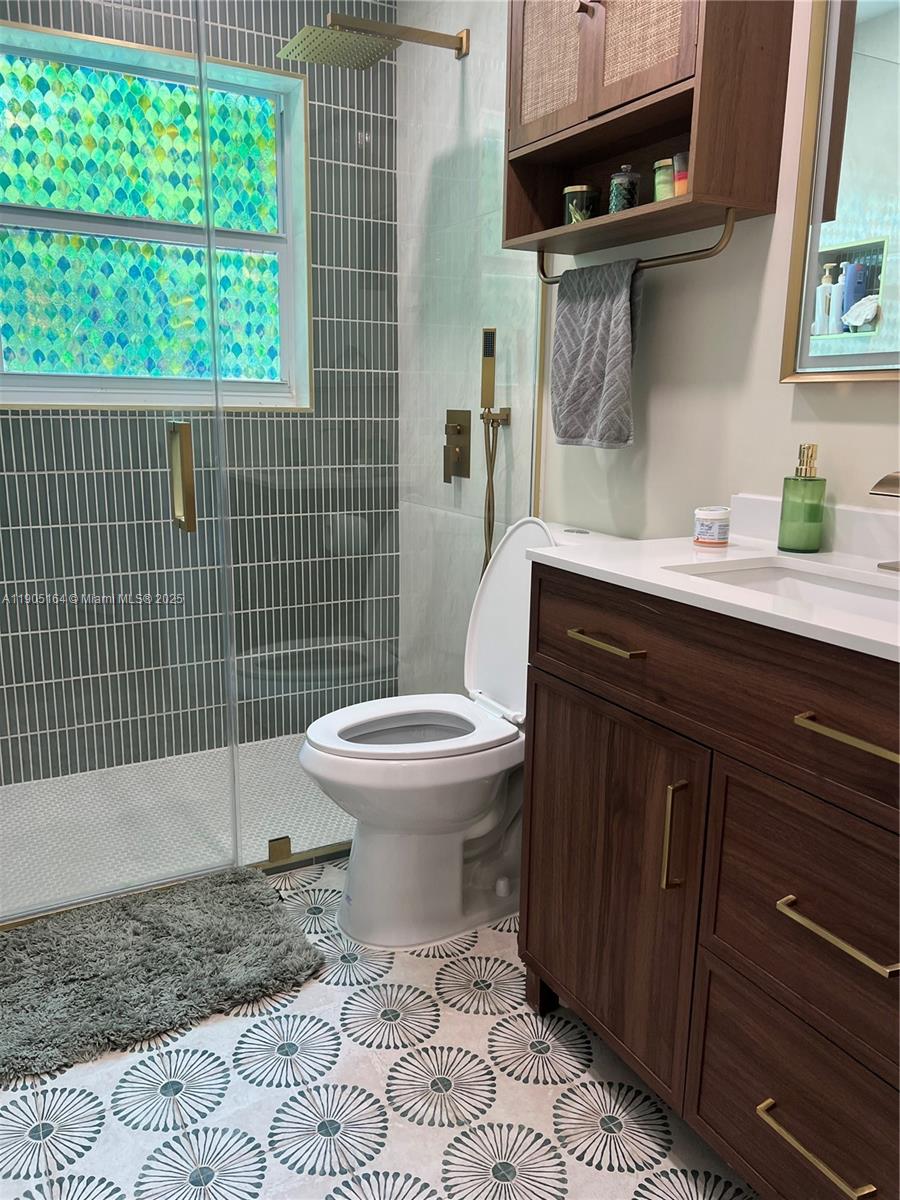 59 Tarpon Avenue Key Largo, FL 33037 - Photo 9 of 16 a bathroom with a toilet a sink and window