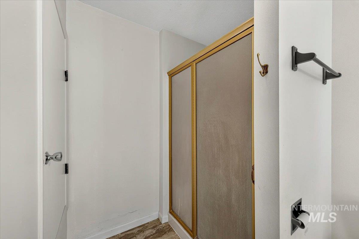 2160 South Five Mile Road Boise, ID 83709 - Photo 23 of 41 Shower enclosure with gold-tone framing and frosted glass panels