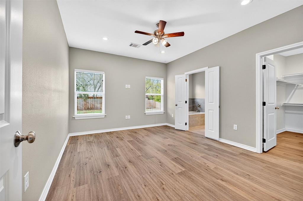 508 Goodjohn Street Collinsville, TX 76233 - Photo 17 of 40 Unfurnished bedroom with light wood-type flooring, a walk in closet, a ceiling fan, recessed lighting, and ensuite bathroom