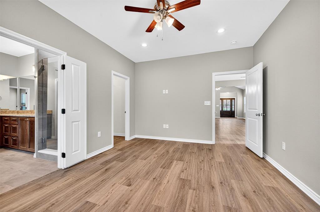 508 Goodjohn Street Collinsville, TX 76233 - Photo 18 of 40 Unfurnished bedroom with light wood-style flooring, ensuite bathroom, ceiling fan, and recessed lighting