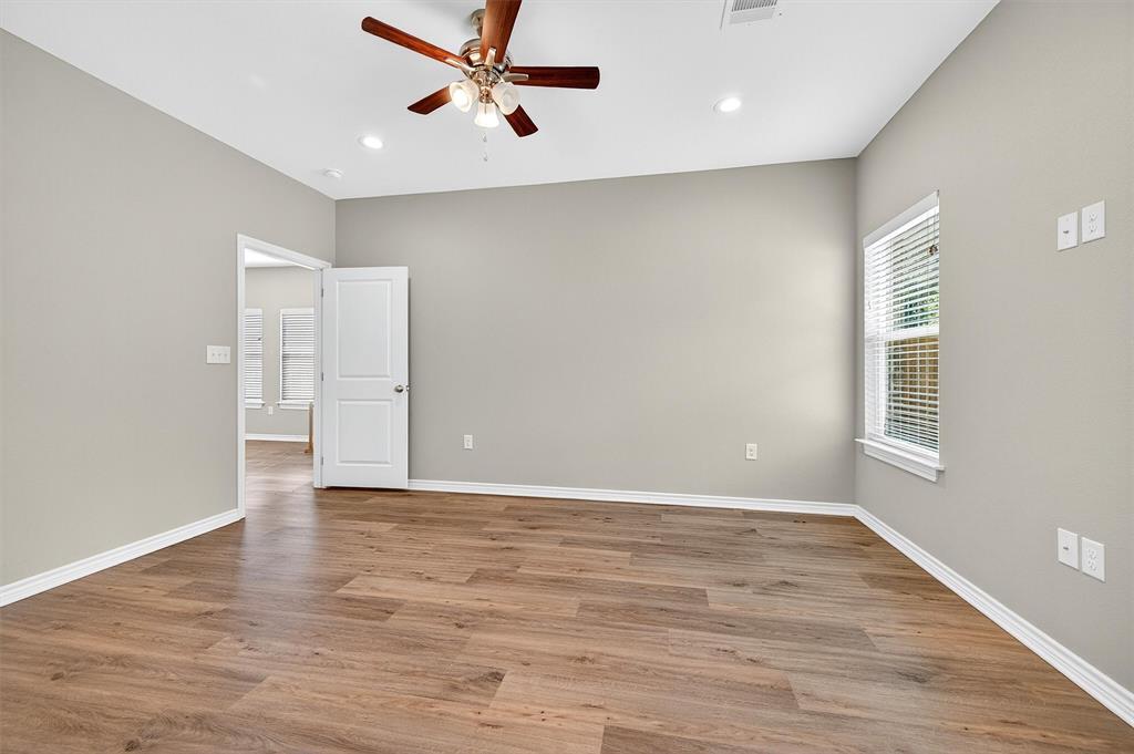 508 Goodjohn Street Collinsville, TX 76233 - Photo 19 of 40 Unfurnished room featuring light wood finished floors, a ceiling fan, and recessed lighting