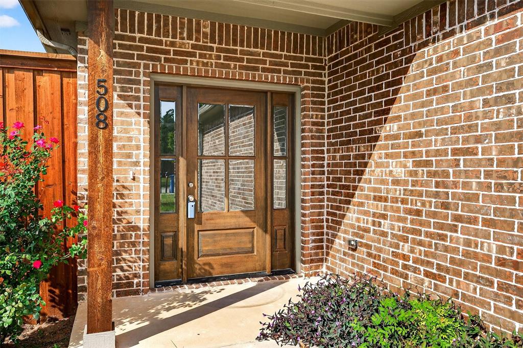 508 Goodjohn Street Collinsville, TX 76233 - Photo 2 of 40 Entrance to property with brick siding and a porch