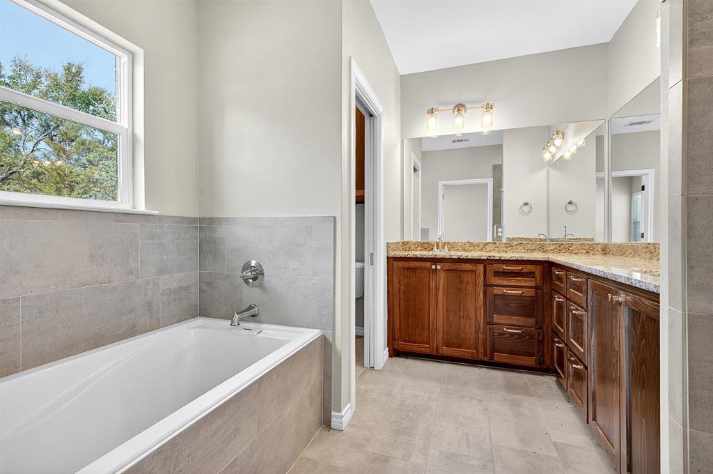508 Goodjohn Street Collinsville, TX 76233 - Photo 21 of 40 Full bath with double vanity and a garden tub