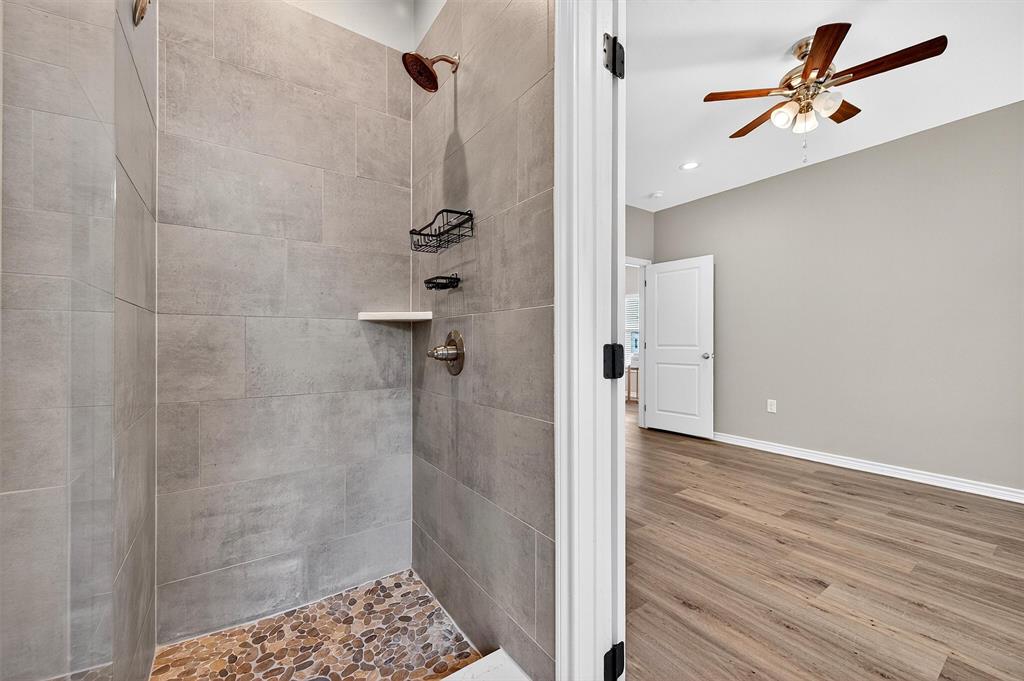 508 Goodjohn Street Collinsville, TX 76233 - Photo 22 of 40 Bathroom with wood finished floors, tiled shower, ceiling fan, and recessed lighting