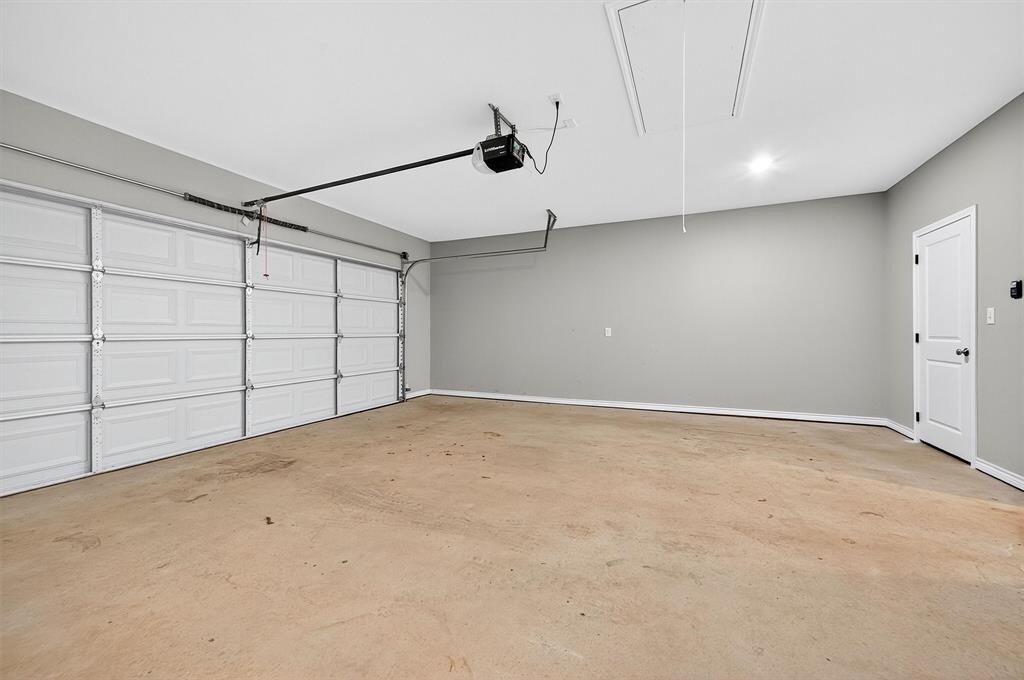 508 Goodjohn Street Collinsville, TX 76233 - Photo 28 of 40 Garage featuring a garage door opener and baseboards