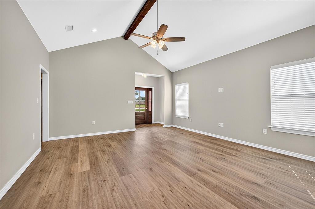 508 Goodjohn Street Collinsville, TX 76233 - Photo 6 of 40 Spare room with beam ceiling, light wood-style flooring, high vaulted ceiling, and a ceiling fan