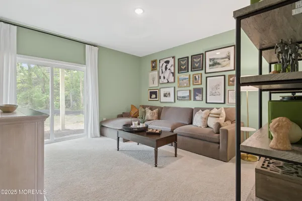 a living room with furniture and a floor to ceiling window