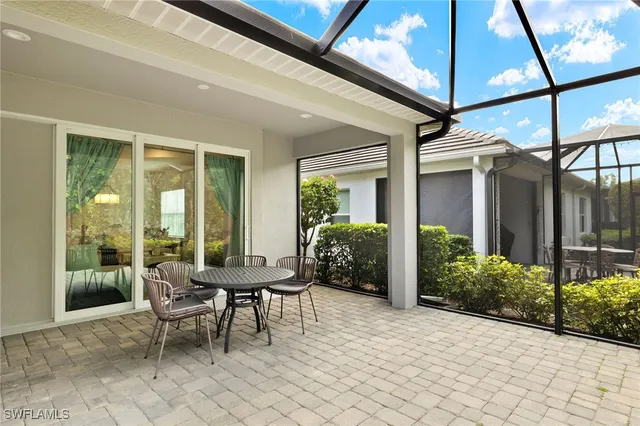 a view of a patio with table and chairs and potted plants