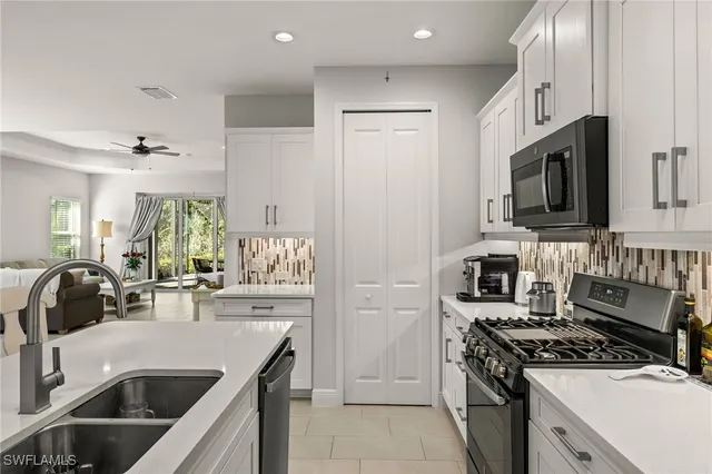 a kitchen with a sink stove and refrigerator
