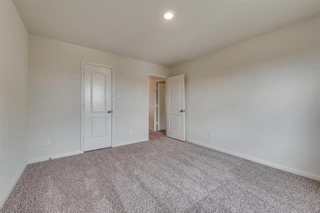 13609 Mineral Road Ponder, TX 76259 - Photo 9 of 21 Spacious room featuring neutral carpet flooring, crisp white walls, and a recessed ceiling light