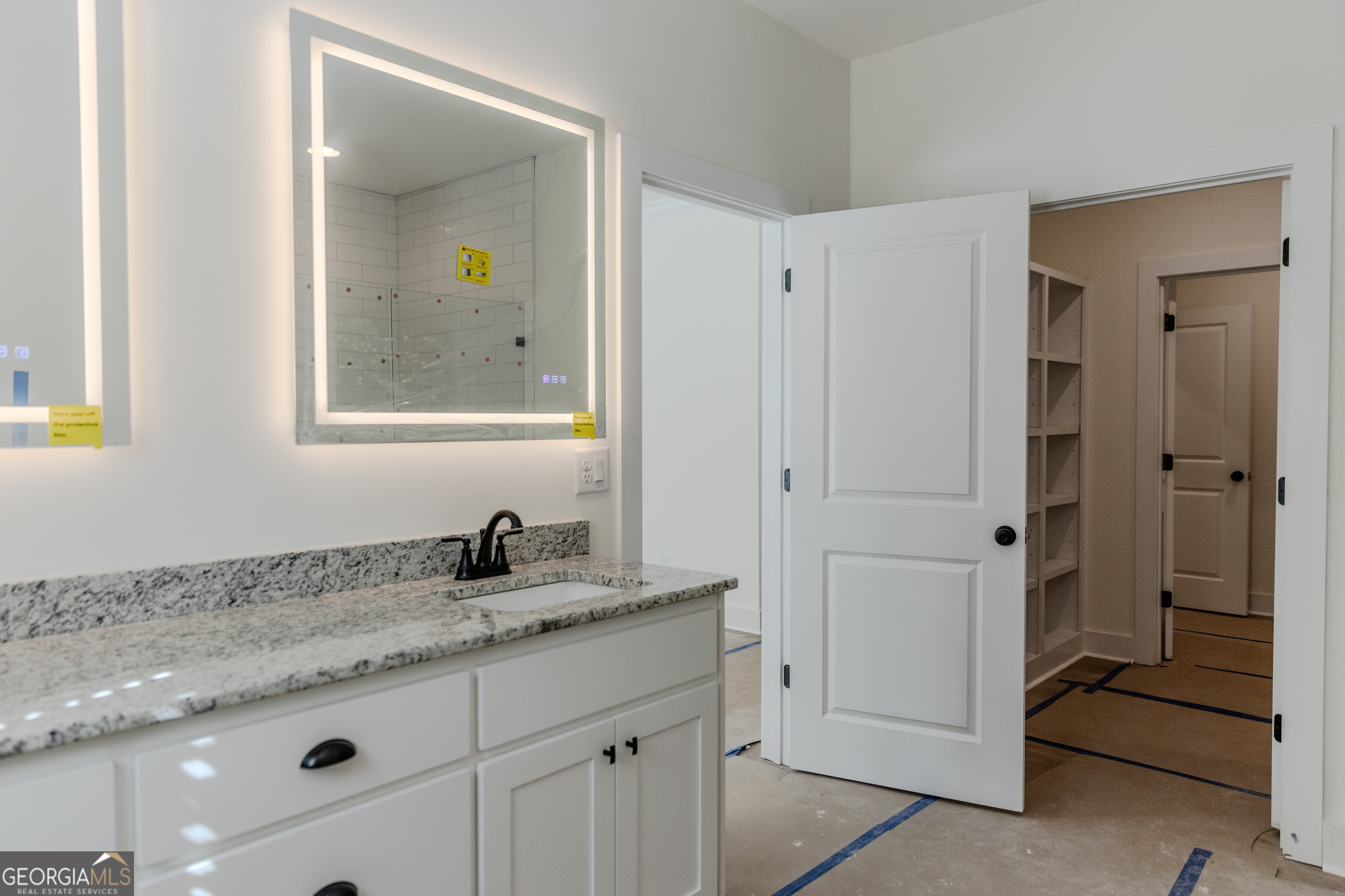 632 Campbell Road Covington, GA 30014 - Photo 21 of 60 a bathroom with a granite countertop sink and a mirror