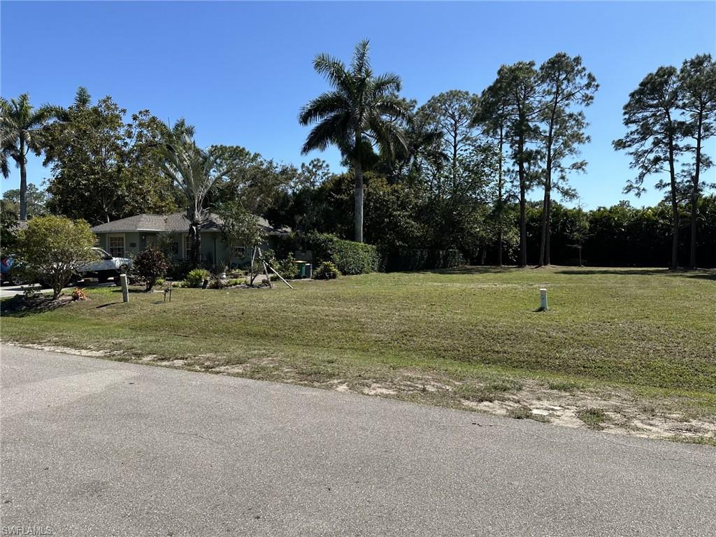 734 Pine Cone Lane Naples, FL 34104 - Photo 2 of 3 a view of a field with grass and trees