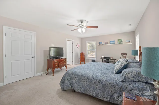 a bedroom with a bed and a tv