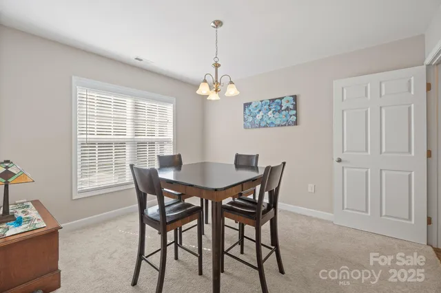 a view of a dining room with furniture and window