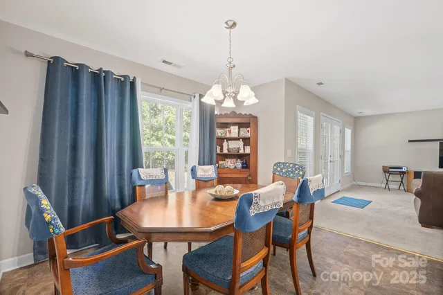 a view of a dining room with furniture and window