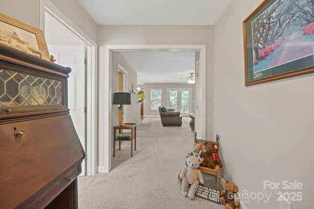 a living room with furniture and a refrigerator