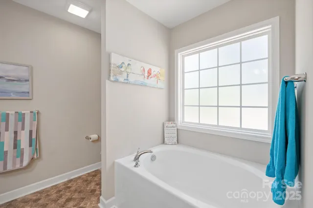 a white bath tub sitting next to a window