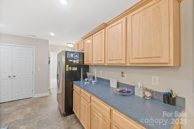 a kitchen with stainless steel appliances granite countertop a refrigerator sink and cabinets