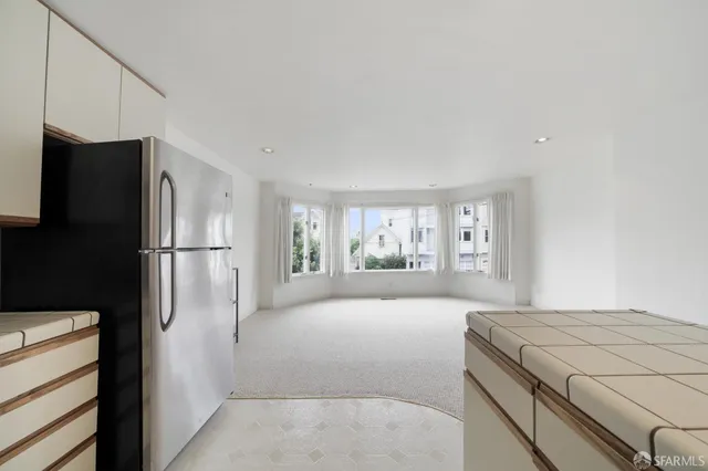 a kitchen with a refrigerator and a window