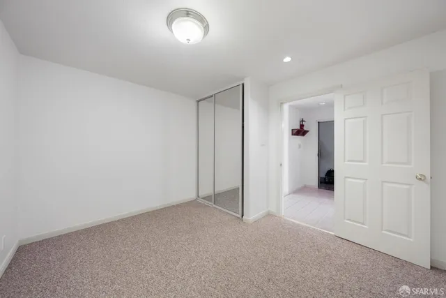 an empty room with closet area