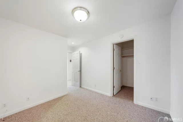 an empty room with a empty space and a window